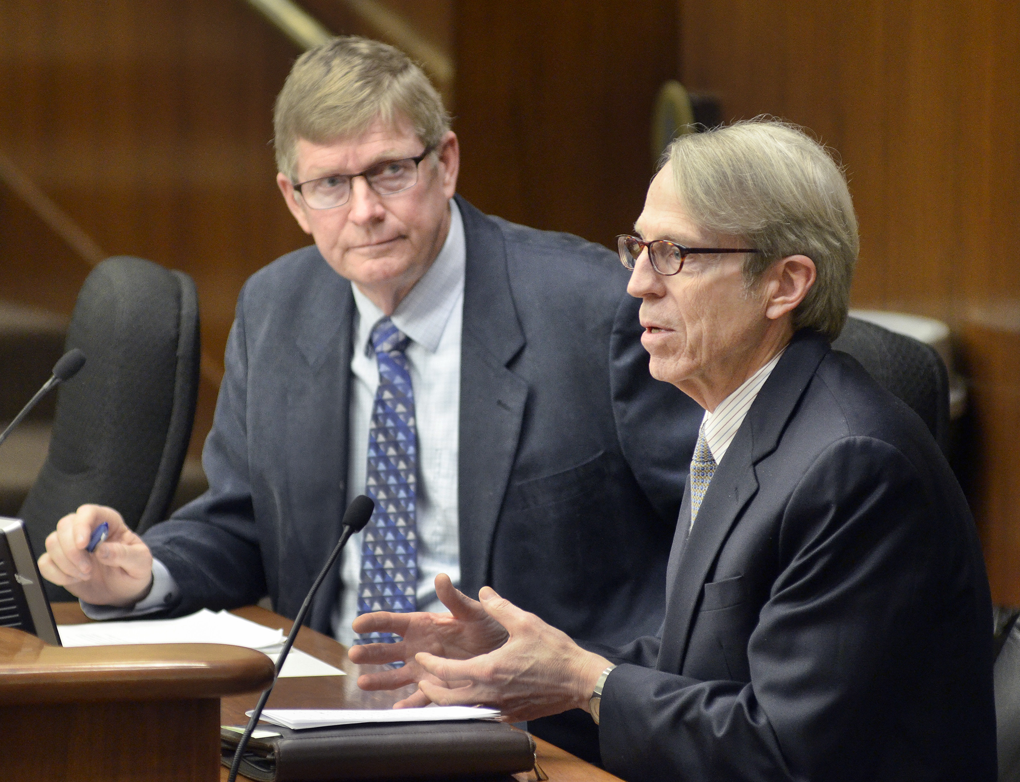 David Thornton, right, assistant commissioner at the Pollution Control Agency, testifies Feb. 25 with concerns on a bill sponsored by Rep. Paul Anderson, left, that would prohibit wood-burning heater regulations.  Photo by Andrew VonBank